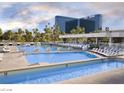 Expansive outdoor swimming pool with clear blue water and comfortable lounge chairs at 135 E Harmon Ave # 307, Las Vegas, NV 89109