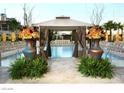 Inviting poolside cabana with elegant decor and lush landscaping features at 135 E Harmon Ave # 307, Las Vegas, NV 89109