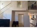 Stairway landing view of kitchen and chairs below at 201 Fig Ct, Las Vegas, NV 89145