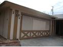 View of the 2-car garage with a door featuring unique criss-cross panel detailing at 224 S Wallace Dr, Las Vegas, NV 89107