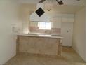 Cozy kitchen featuring a breakfast bar with a tile front, enhancing the dining area at 224 S Wallace Dr, Las Vegas, NV 89107