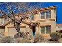 Two-story home featuring neutral stucco, tiled roof, and mature landscaping at 262 Calvino Ave, Las Vegas, NV 89183