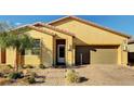 Inviting single-story home with desert landscaping, a brick driveway, and a cozy front porch at 3026 English Palmer Rd, North Las Vegas, NV 89086