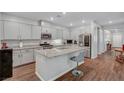 Modern kitchen featuring granite countertops, stainless steel appliances, and a spacious center island with bar seating at 3026 English Palmer Rd, North Las Vegas, NV 89086