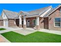 Inviting brick home featuring manicured front yard and covered porch at 3196 Mateuse St, Logandale, NV 89021