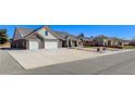 Lovely brick home featuring a three car garage and inviting walkway with blue skies at 3196 Mateuse St, Logandale, NV 89021