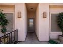 Welcoming front entrance with decorative sconces and wrought iron gate, creating a warm and inviting arrival at 328 Vineyard Ln, Mesquite, NV 89027