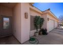 Charming facade with potted plants and sidelight windows by the front door and garage at 328 Vineyard Ln, Mesquite, NV 89027