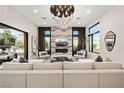 Open concept living room features modern chandelier, fireplace, and large sliding doors to the outdoor area at 333 Highview Ridge Ave, Las Vegas, NV 89138