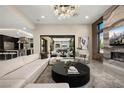 Bright living room with sliding doors and a modern chandelier, with a glimpse of the kitchen in the background at 333 Highview Ridge Ave, Las Vegas, NV 89138