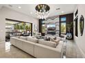 Elegant living room with a stylish chandelier, fireplace, and sliding glass doors leading to the outdoor patio at 333 Highview Ridge Ave, Las Vegas, NV 89138