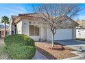 Inviting single-story home boasts desert landscaping and a two-car garage, offering curb appeal at 3505 Tuscany Village Dr, Las Vegas, NV 89129