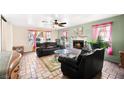 Cozy living room with a marble fireplace and bright windows adorned with colorful sheer curtains at 3620 Bahama Bay Ct, Las Vegas, NV 89147