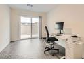 Bright office space with sliding glass doors, modern desk, and gray laminate flooring at 3772 Brilliant Sunset St, Las Vegas, NV 89129