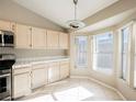 Bright kitchen featuring white cabinets, tile countertops and floors with a charming breakfast nook area at 4016 Fairport Dr, North Las Vegas, NV 89032