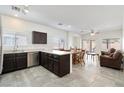 Open-concept kitchen with stainless steel appliances flowing into the dining and living areas at 6314 Ruby Cedar Ct, North Las Vegas, NV 89031