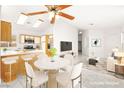 Open-concept dining area with marble table, seating for four, and views of the kitchen at 6653 Lund Dr, Las Vegas, NV 89108