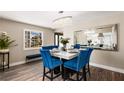 Elegant dining room with blue velvet chairs, a modern chandelier, and a large mirror at 7229 Mira Vista St, Las Vegas, NV 89120