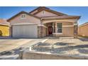 Exterior elevation of home with a two-car garage, stone accents and desert landscaping at 7308 Alpine Ridge St, Las Vegas, NV 89131