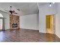 Spacious living room featuring stylish floors, a stone fireplace, and access to the outdoors at 8301 Boseck Dr # 215, Las Vegas, NV 89145