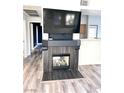 View of the fireplace with a mounted television, adjacent to the entry hallway at 9050 W Warm Springs Rd # 2016, Las Vegas, NV 89148