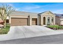 Attractive single-story home with three-car garage and inviting curb appeal enhanced by manicured landscaping at 920 Claystone Ridge Ave, North Las Vegas, NV 89084