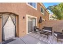 The private back patio features outdoor seating, and access to the home through the sliding glass door at 9655 Idle Spurs Dr, Las Vegas, NV 89123