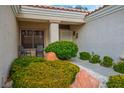 Inviting front porch with mature landscaping and seating area at 10320 Bent Brook Pl, Las Vegas, NV 89134