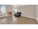 Bright living room with a fireplace, wood floors, and an abundance of natural light at 104 Hutton Ln, Las Vegas, NV 89145