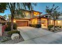 Attractive two-story home boasting a two-car garage, stone details, and well-maintained landscaping at 10564 Tranquil Glade Ln, Las Vegas, NV 89135