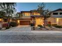 Charming two-story home featuring a 2-car garage, with stone accents and tasteful landscaping at 10564 Tranquil Glade Ln, Las Vegas, NV 89135