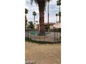 Fenced community pool area with palm trees and shaded seating at 1405 Vegas Valley Dr # 360, Las Vegas, NV 89169