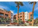 Exterior of property showcasing desert landscaping and multi-story buildings with balconies and architectural details at 19 E Agate Ave # 406, Las Vegas, NV 89123