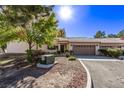 Single-story home featuring desert landscaping, a tile roof, and an attached two car garage at 1911 Hobson Dr, Henderson, NV 89074