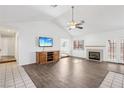 Bright living room features wood floors, ceiling fan, fireplace, and sliding doors to the exterior at 1911 Hobson Dr, Henderson, NV 89074