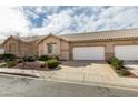 Charming single-story home featuring a two-car garage, desert landscaping, and a tile roof at 205 Crown Imperial St, Henderson, NV 89074