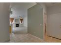 Inviting living room with fireplace, neutral paint, tile floors near entry, and plush carpet at 205 Crown Imperial St, Henderson, NV 89074