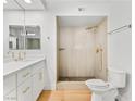 Bright bathroom featuring a new vanity with stone countertop and a modern walk-in shower with gold fixtures at 2620 San Martin Ct, Las Vegas, NV 89121