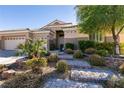 Beautifully landscaped front yard with stone steps leading to the entrance at 2713 Tanagrine Dr, North Las Vegas, NV 89084