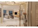 Modern living room with marble floors, entertainment center, and access to beautiful city views at 2747 Paradise Rd # Ph 3604, Las Vegas, NV 89109