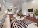 Bright living room with hardwood floors, a staircase, and stylish contemporary decor at 2756 Blairgowrie Dr, Henderson, NV 89044