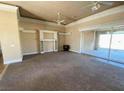 Spacious living room with neutral paint, carpet flooring, and sliding glass doors at 4320 Tiger Rd, Pahrump, NV 89048