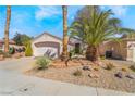 Single story home with desert landscaping and mature palm trees at 502 Edgefield Ridge Pl, Henderson, NV 89012