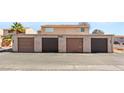 Exterior shot of garage featuring multiple brown doors and number 5166 at 5166 Gray Ln # M, Las Vegas, NV 89119