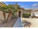 Home exterior featuring a tiled roof, small shrubs, and desert rock landscaping at 5323 Farley Feather Ct, North Las Vegas, NV 89031