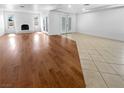 Spacious living room featuring a fireplace, recessed lighting, and combination wood and tile flooring at 5413 Avenida Caballo, Las Vegas, NV 89108