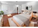 Serene main bedroom featuring natural light, neutral decor, hardwood floors, and a double-door closet at 5413 Avenida Caballo, Las Vegas, NV 89108