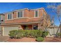 Two-story home with a neutral-toned exterior, a two-car garage, and manicured landscaping at 6190 Tillman Crest Ave, Las Vegas, NV 89139