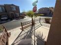 View of the wrought iron fenced front yard, landscaping, and neighborhood streets at 6320 Tier Ave, Las Vegas, NV 89139