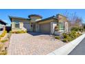 Attractive single-story home featuring a brick-paved driveway, desert landscaping, and an attached garage at 6722 Desert Crimson St, Las Vegas, NV 89148